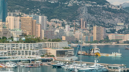 Naklejka premium Monte Carlo city aerial panorama timelapse. View of luxury yachts and buildings in harbor of Monaco, Cote d'Azur.