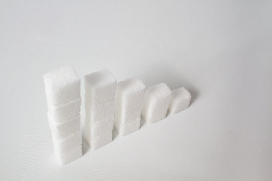 High Key Of Five Collumns Made Of Sugar Cubes With Decreasing Height Symbolizing The Need Of Reducing Sugar Consumption