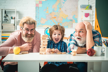 Grandfather Father and son playing indoors. Grandfather father and son having fun together.