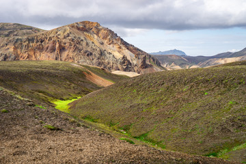 Landmannalaugar Valley. Iceland. Colorful mountains on the Laugavegur hiking trail. The combination of layers of multi-colored rocks, minerals, grass and moss