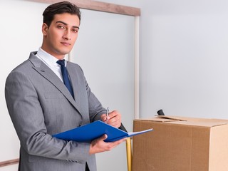 Man signing for the delivery of boxes