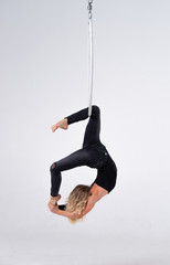 Slim and flexible Girl In An aerial hoop isolated On A White Background