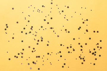 carnival party background. shining sparkles on a yellow background. horizontal image