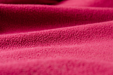 Fototapeta na wymiar Wave-like folds on the fabric. Crumpled textiles, background.
