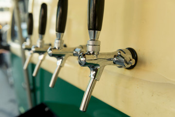 The beer taps in a side of a vintage van.