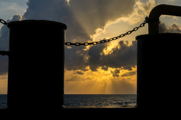 Silhouette of mooring bitts on board a construction work barge at oil field