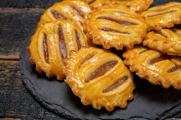 Small round fresh baked cookies filled with apples jam