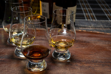 Tasting of flight of Scotch whisky from special tulip-shaped glasses on distillery in Scotland, UK
