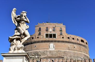 View of Castel Sant’Angelo and marble angel from Ponte Sant'Angelo with blue sky. Rome, Italy.