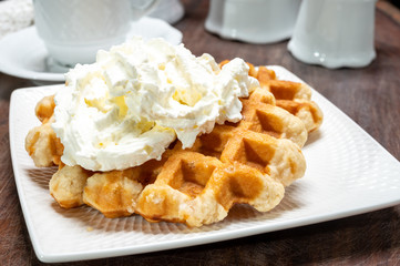 Tasty Belgian dessert, Brussels sugar waffles with  whipped cream