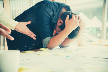 A young businessman holds his head in the head due to disappointment. From operating results with...
