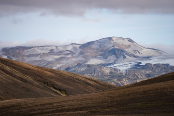 Fototapeta premium Beautiful landscape with glacier, hills and moss on the Fimmvorduhals trail near Landmannalaugar of summer sunny day, Iceland
