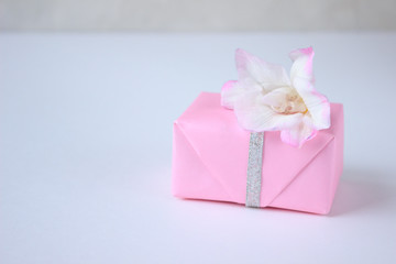 pink box on light gray background, spring minimalism gift concept