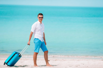 Young man on the beach having fun