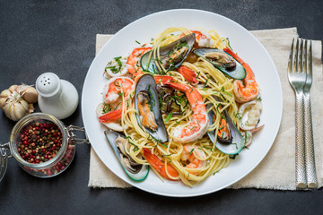 Fresh Spaghetti pasta with seafood on old kitchen table.