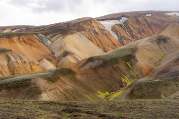 Landmannalaugar Colorful mountains on the Laugavegur hiking trail. Iceland. The combination of layers of multi-colored rocks, minerals, grass and moss