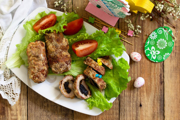 Festive appetizer. Meatloaf with prunes on the festive Easter table. Top view flat lay background. Copy space.