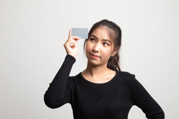 Young Asian woman think with a blank card.