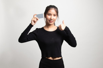 Young Asian woman thumbs up with a blank card.