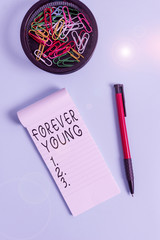 Conceptual hand writing showing Forever Young. Concept meaning mindset of a being fresh and...