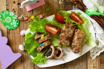 Festive appetizer. Meatloaf with prunes on the festive Easter table. Top view flat lay background.
