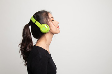 Pretty asian girl listening music with her headphones.