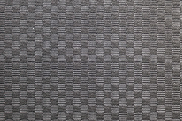 Seamless textile black checkered fabric material. Dark color background with squares.