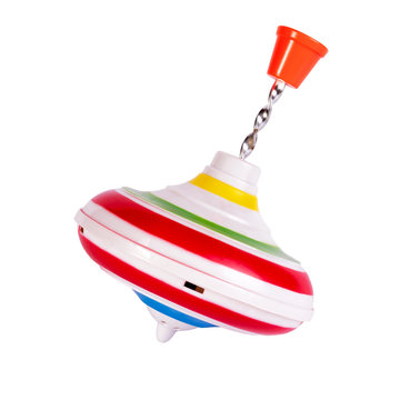 Multicolored plastic spinning top or whirligig top is traditional toy for preschool childs.Boys and girls with pleasure watching them spin. Isolated on white.