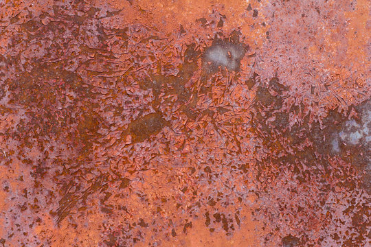 Brown and purple rust Rusty brown abstract texture. Rusty metal background. Rusty metal wall. Rusty metal surface with remnants of red paint.