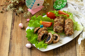 Festive appetizer. Meatloaf with prunes on the festive Easter table. Copy space.