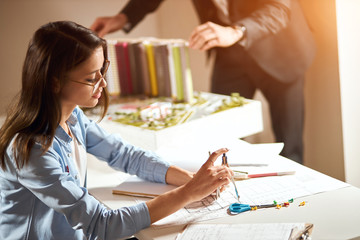 attractive female architect enjoying her work, team work, close up side view photo