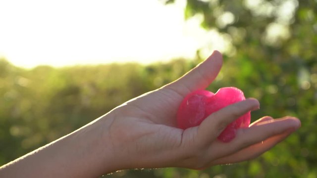 Closeup view 4k video of hand of young white kid playing slime gum toy outdoors.