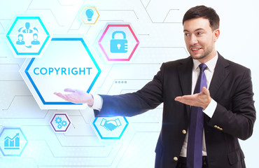 Business, Technology, Internet and network concept. Young businessman working on a virtual screen of the future and sees the inscription: Copyright