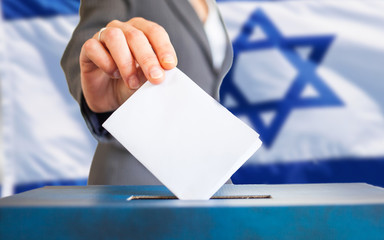 israel elections hand putting vote in ballot
