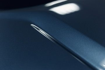 The car's paintwork. Abstract background in classic blue. Trend color. Close up. The texture of the paint