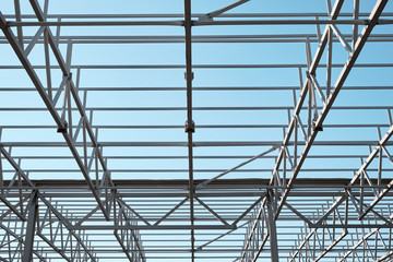 Naklejka premium Metal constructions. Large warehouse building under construction