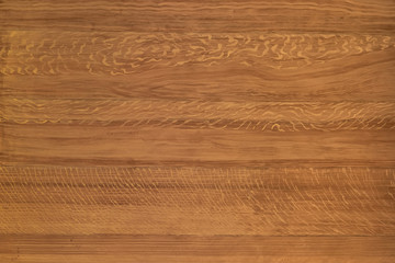 The wood surface is light brown. Background or screen saver. Textural lines of light and dark color.