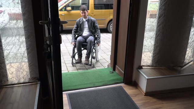 a man in a wheelchair cannot drive into a small shop