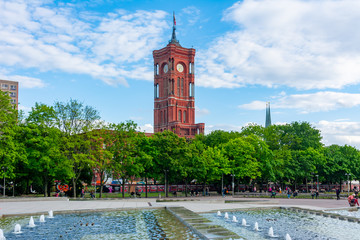 Red Town Hall (Rotes Rathaus) and fountains on Alexanderplatz square, Berlin, Germany