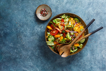 Fresh vegetable salad in a bowl. Top view, copy space.