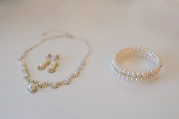 Jewelry for the bride: necklace, earrings and bracelet with pearl beads. Selective focus
