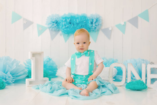 A cute beautiful one-year-old boy is celebrating his first birthday.Photo zone for the holiday