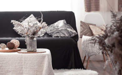 Home cozy still life with a black sofa and decor in the living room.