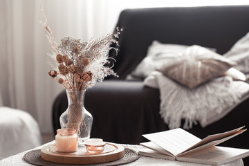 Home cozy still life with a black sofa and decor in the living room.