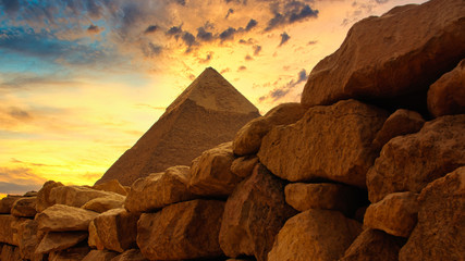 The Chephren pyramid behind a historic stone wall at Giza in Egypt