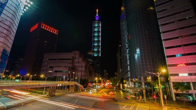 Taipei 101 tower with traffic on road at night in Taipei, Taiwan