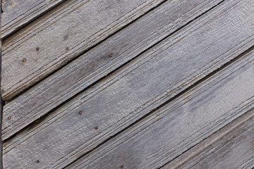 Texture of old weathered wooden fence or wall. Textured surface of brown wood (hardwood) close up....