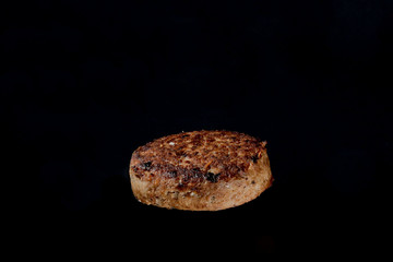 cutlet on burger on a black background
