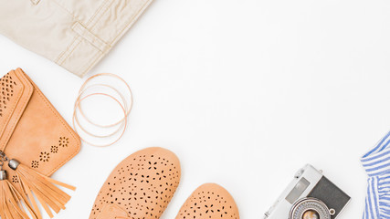 Flat lay female fashion look with stylish clothes and accessories on a light background