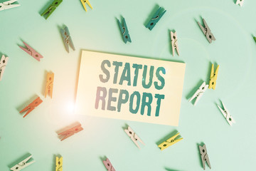 Conceptual hand writing showing Status Report. Concept meaning document relating a situation of something such as a project Colored clothespin rectangle shaped paper blue background